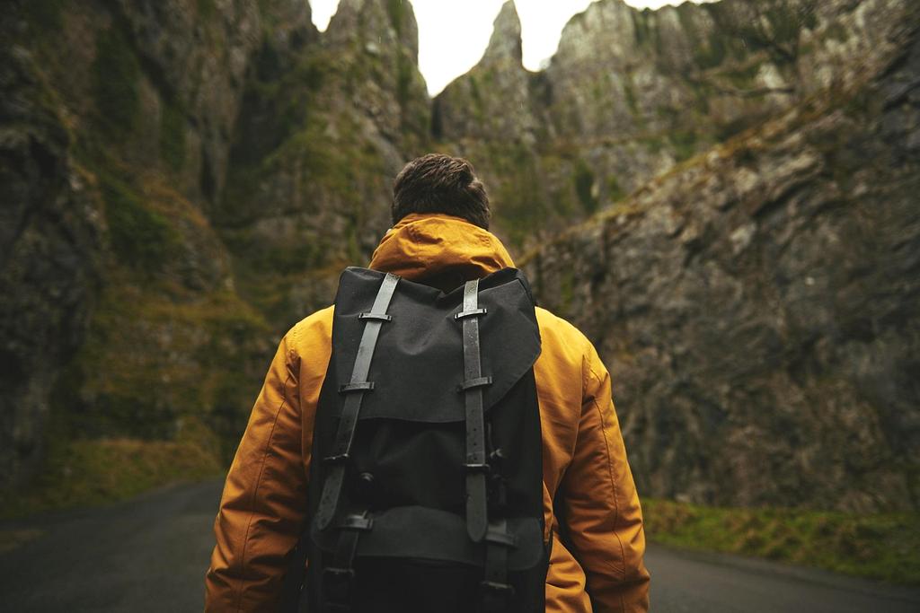 Adventurer trekking a mountain trail during sunset