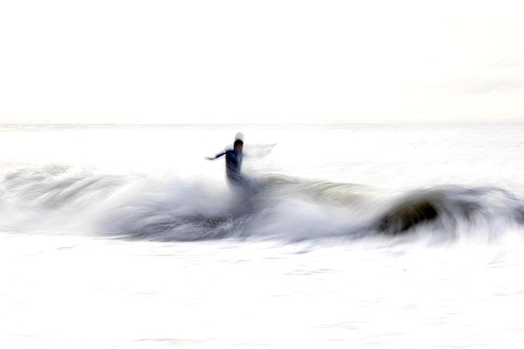 Traveler relaxing on hammock with beach gear and luggage nearby