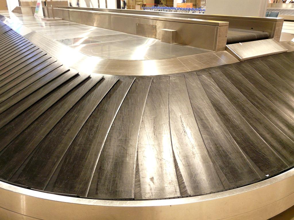 Leisure traveler enjoying a sunny beach with perfectly packed luggage