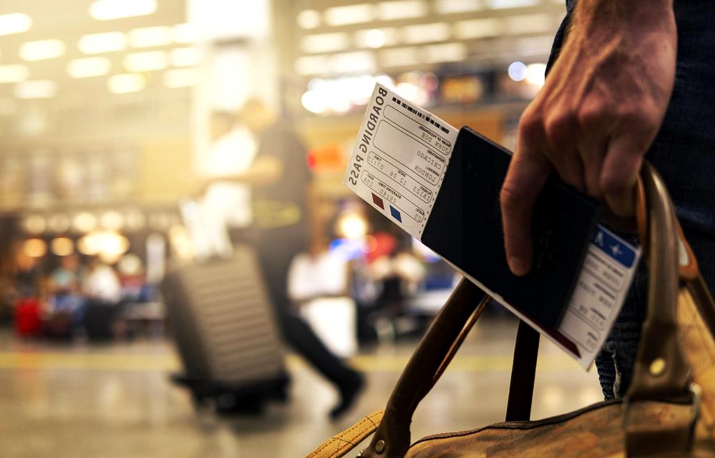 Professional traveler with perfectly organized luggage in modern airport terminal